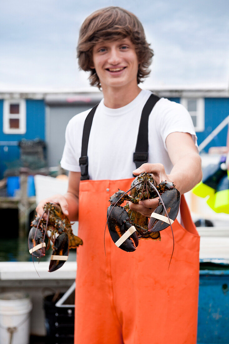 Teenage lobsterman apprentice shows off recent catch of lobsters