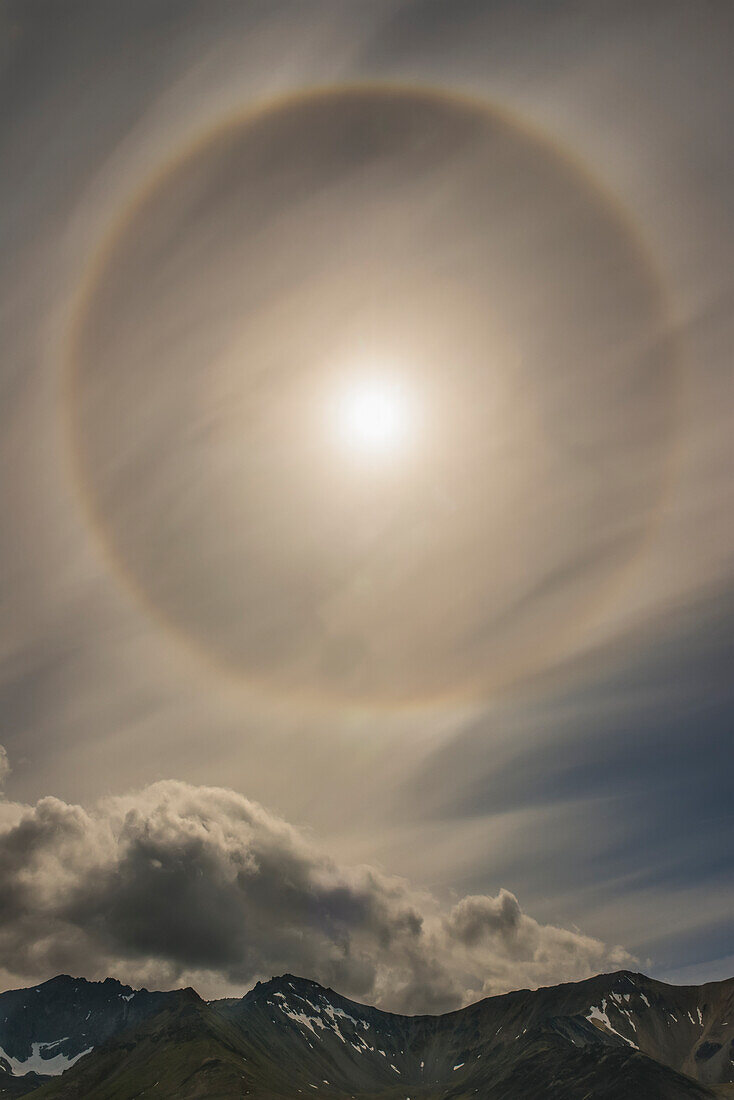 A 22 degree halo fills the sky over the Chigmit Mountains within Lake Clark National Park & Preserve, Alaska.