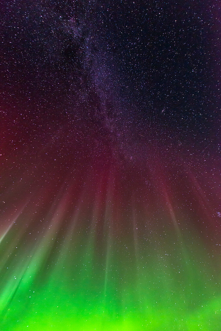 The aurora borealis reaches up to the Milky Way over the 20 Mile River in Chugach National Forest, Southcentral Alaska.