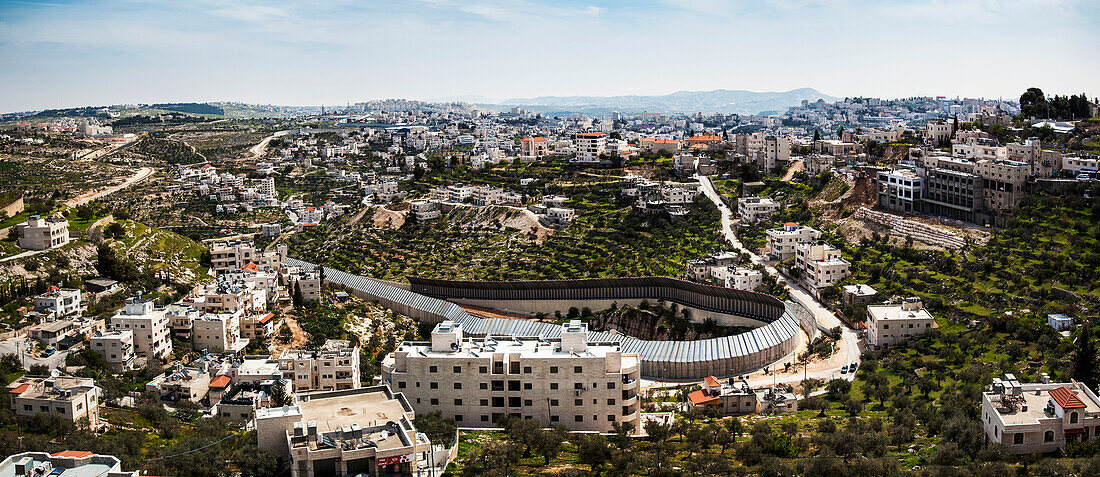 'Circular protection wall surrounding a tunnel that goes from Israel under Palestine and comes out to another part of Israel; Israel'