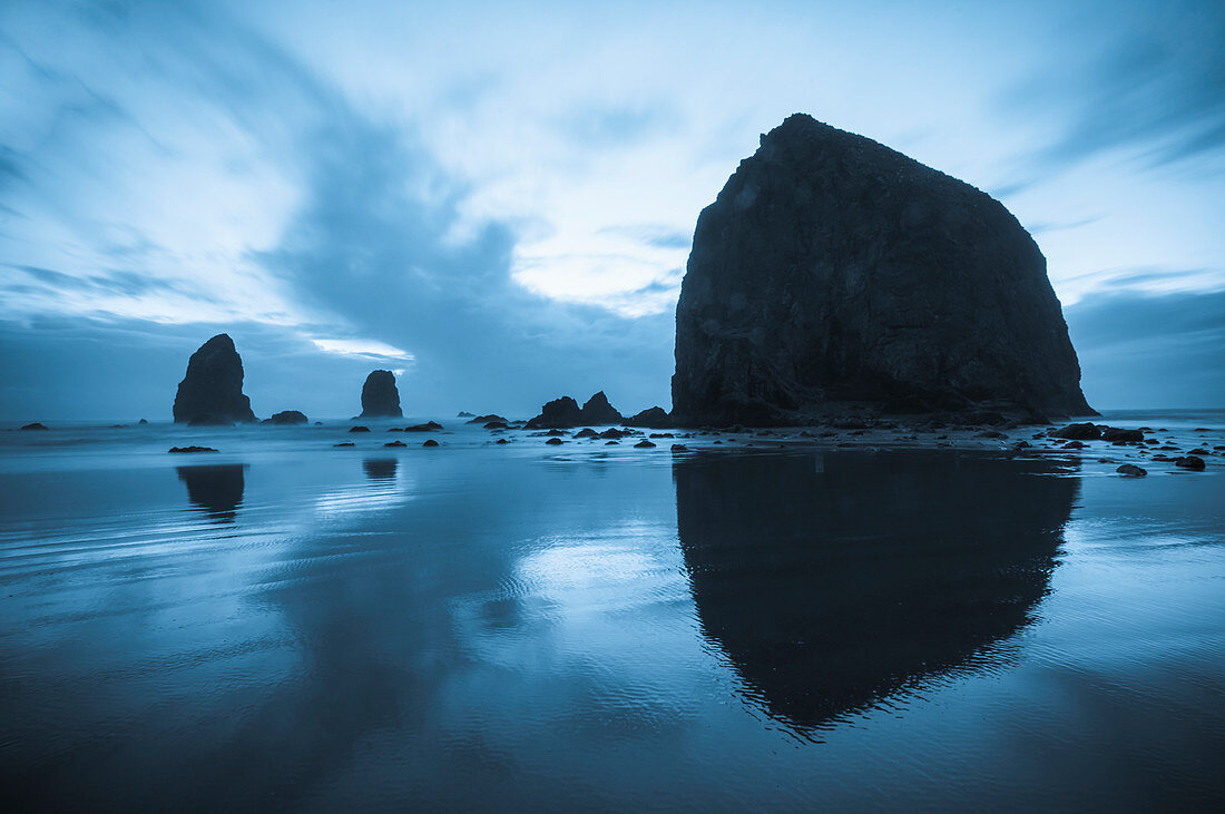 'Greyish blue colors of dusk behind Haystack Rock; Cannon Beach, Oregon, United States of America'