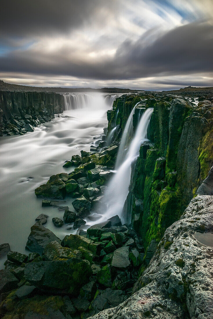 'Waterfall flowing over moss covered cliffs; Selfoss, Iceland'