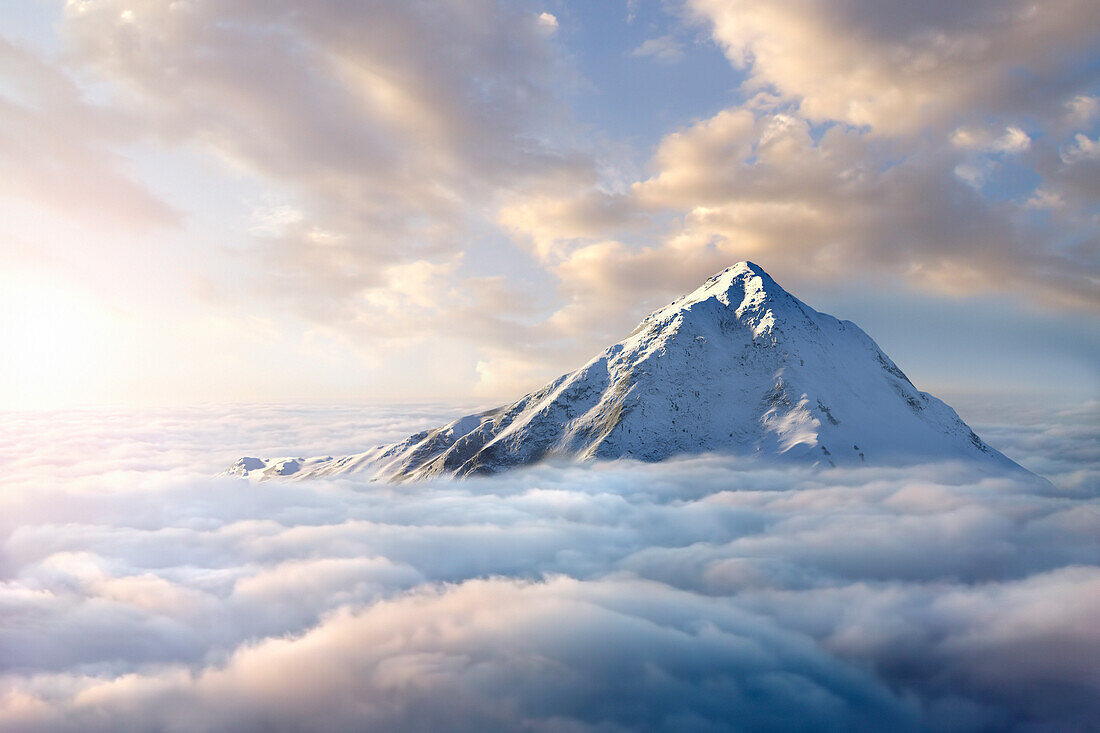 Snow-covered mountaintop above clouds