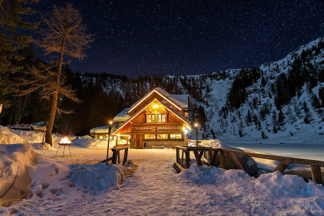 Italy, Trentino Alto Adige, starry night over Nambino refuge in natural park Adamello Brenta.