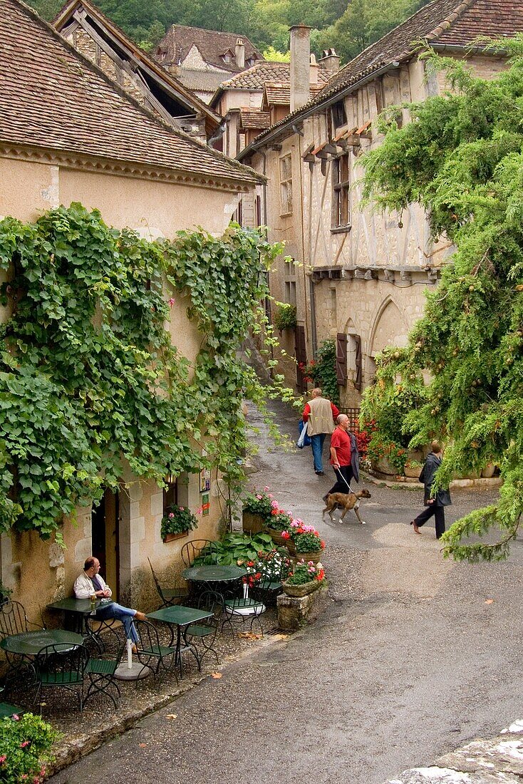 Europe, France, Quercy, Lot, 46, St Cirq Lapopie, tourists amongst the quaint old stone houses lining the streets.