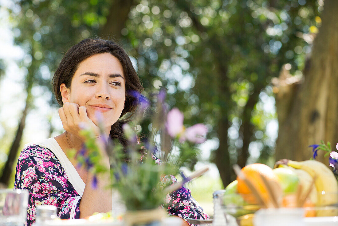 Woman sitting at picnic table