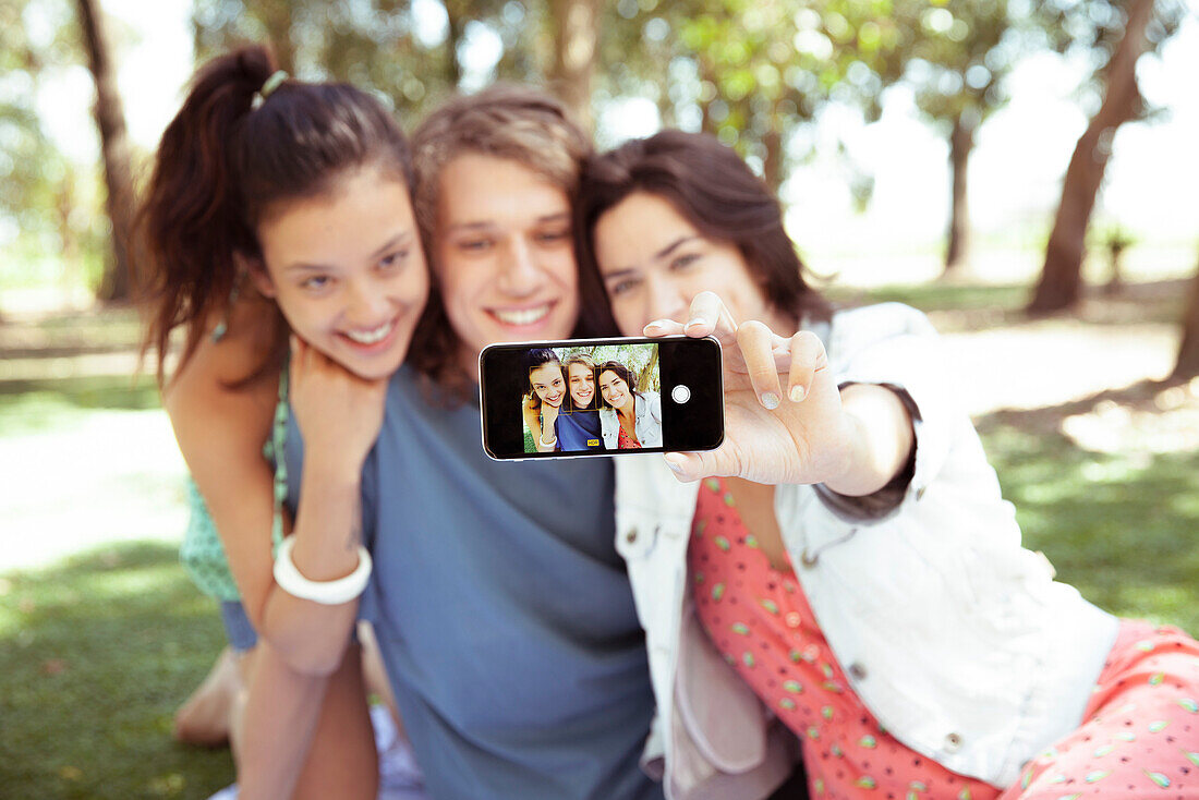 Friends taking selfie together at park