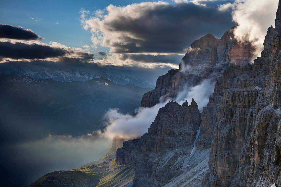 Bocca di Brenta, Brenta dolomites, Adamello Brenta natural park, Trentino, Italy. Clouds into the valley at sunset.