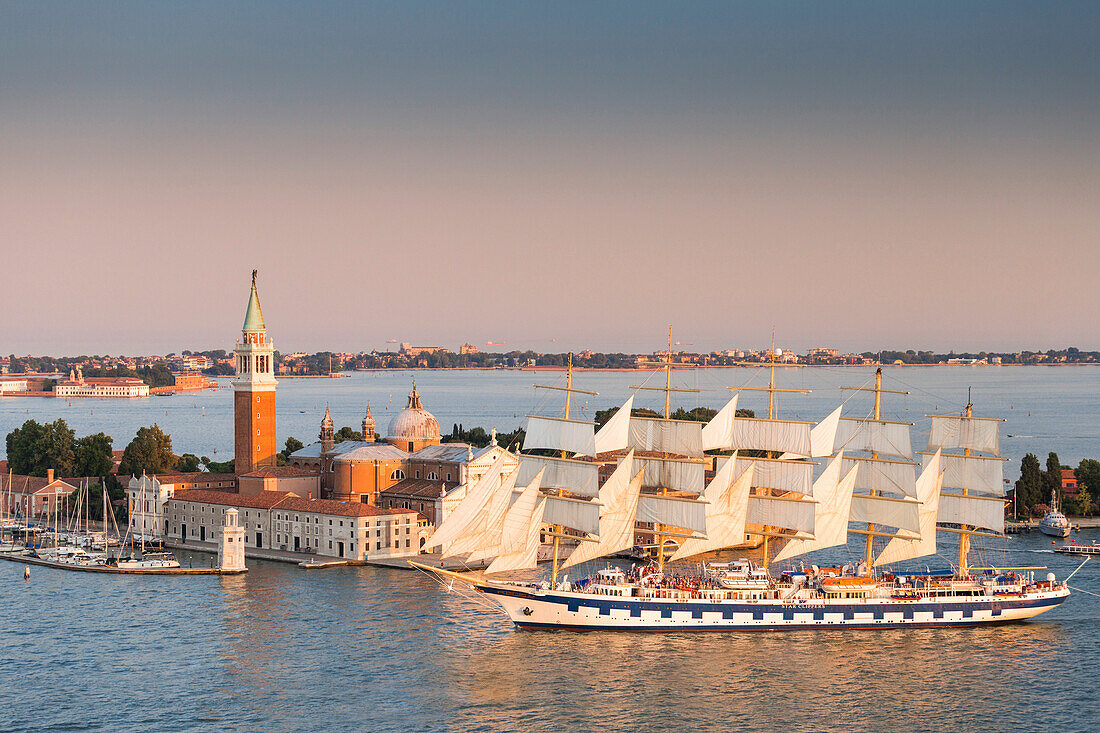 Venice, Veneto, Italy. Sailing ship in St Mark's Basin, in the background San Giorgio Maggiore and Lido Venice.