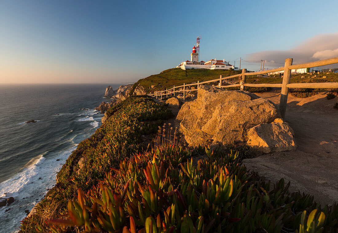 The Cabo da Roca lighthouse overlooks the promontory towards the Atlantic Ocean at sunset Sintra Portugal Europe