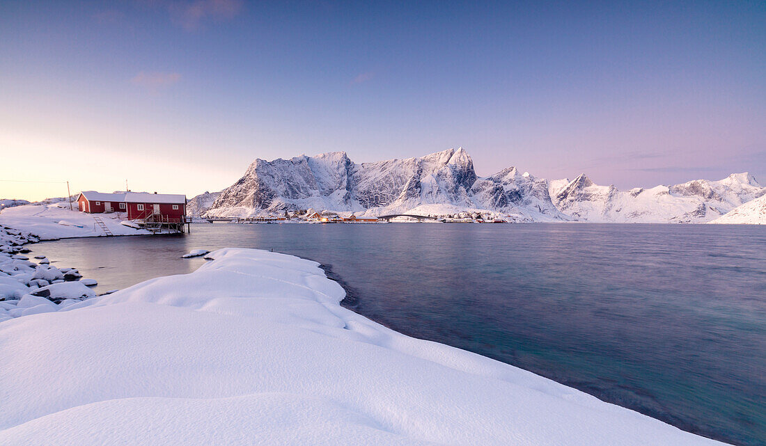 The colors of dawn frames the fishermen houses surrounded by frozen sea Sakris?©y Reine Nordland Lofoten Islands Norway Europe