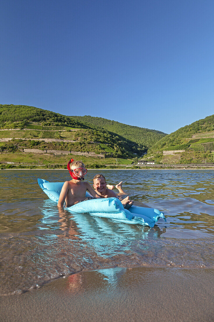 Kids swimming in the Rhine at the beach in Trechtingshausen, Upper Middle Rhine Valley, Rheinland-Palatinate, Germany, Europe