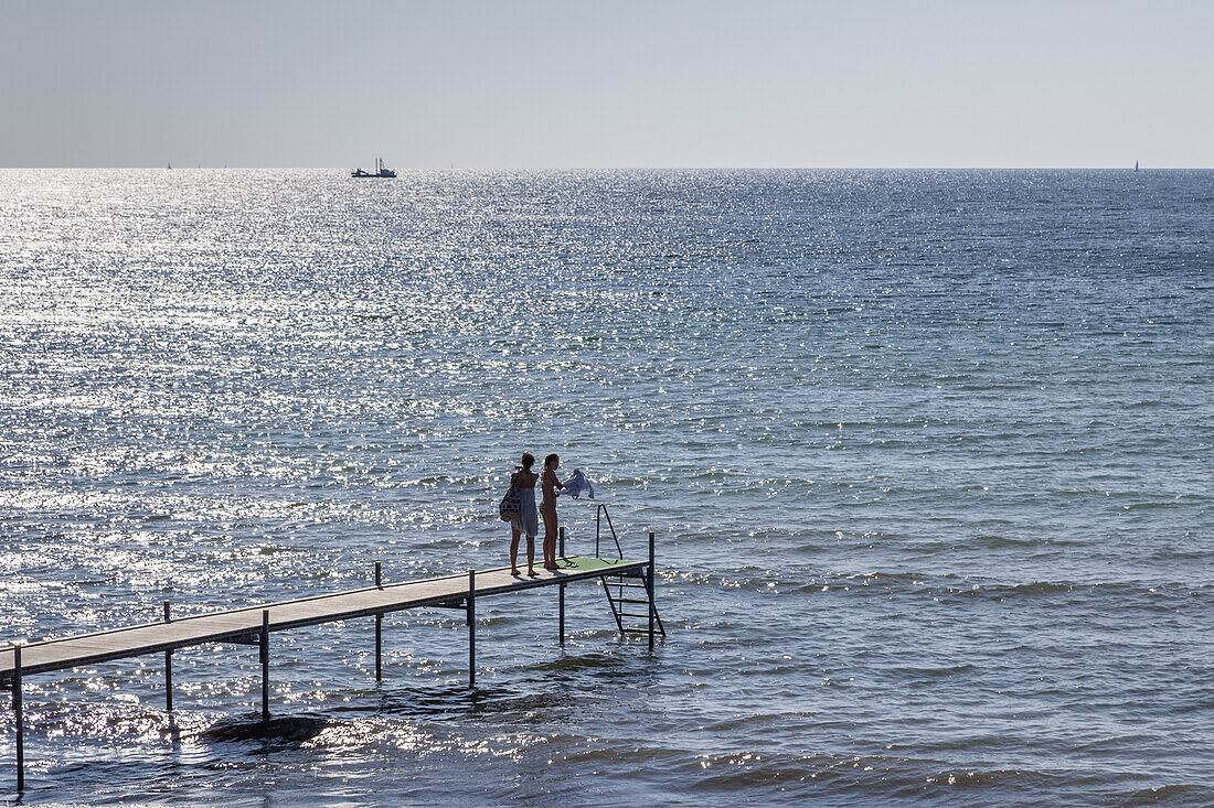 Two persons on a footbridge at the baltic sea, Rødvig, Stevns Peninsula, Island of Zealand, Scandinavia, Denmark, Northern Europe