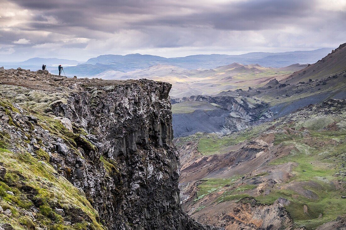 Photographers in top cliff of Haifoss waterfall, South Iceland.