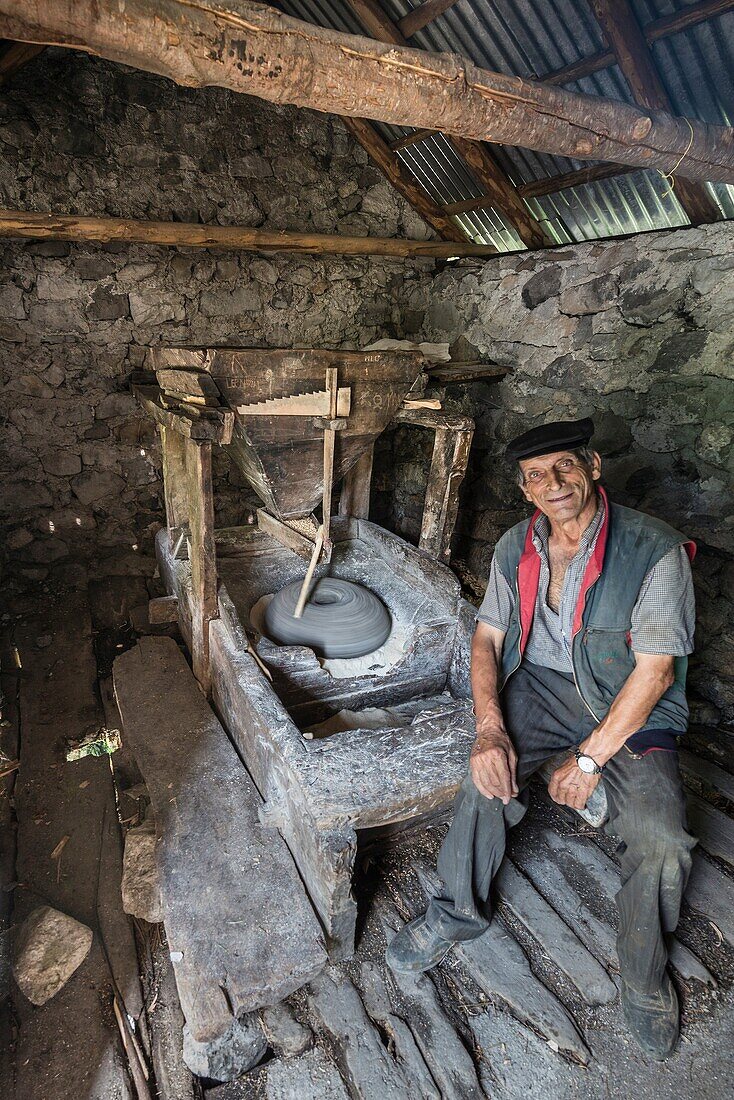Grinding corn in a small comunially owned water mill in the village of Theth in Northern Albania.
