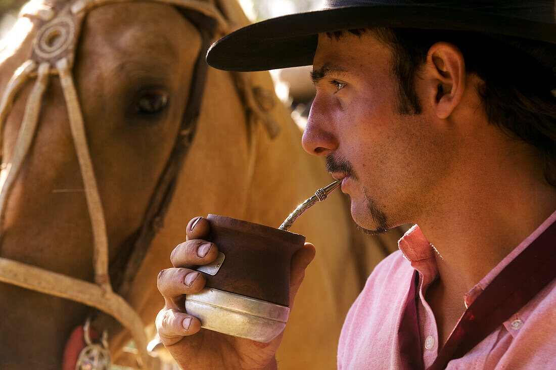 Argentina, Buenos Aires Province, Estancia San Isidro del Llano, gaucho drinking Mate beverage (local herbal tea)