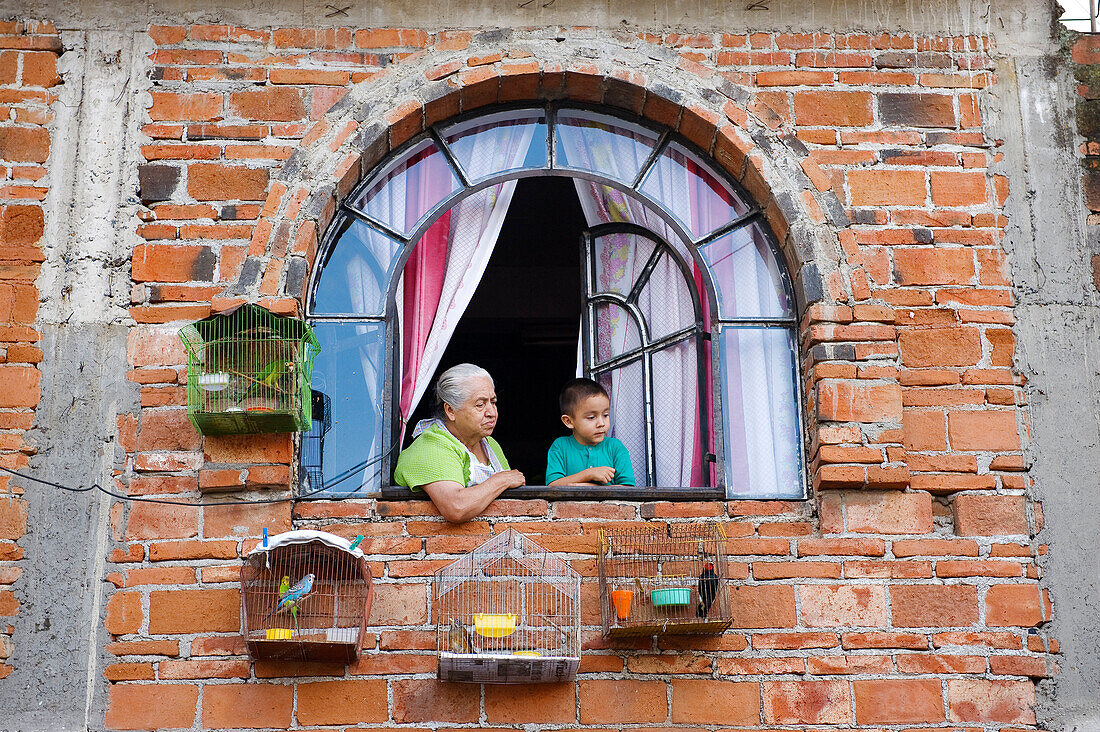 Mexico, Guerrero state, Taxco, the old city, grandmother and her grand-son at the window