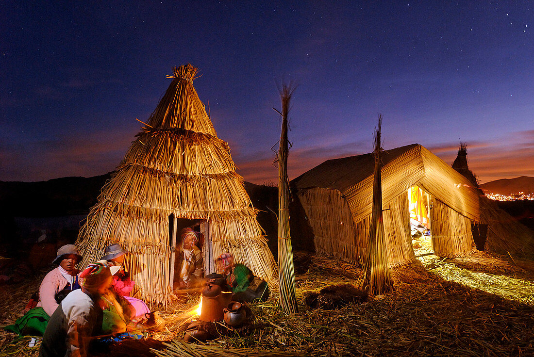 Peru, Puno Province, Titicaca lake, floating islands of Uros, evening family meal at home heated with dried reed