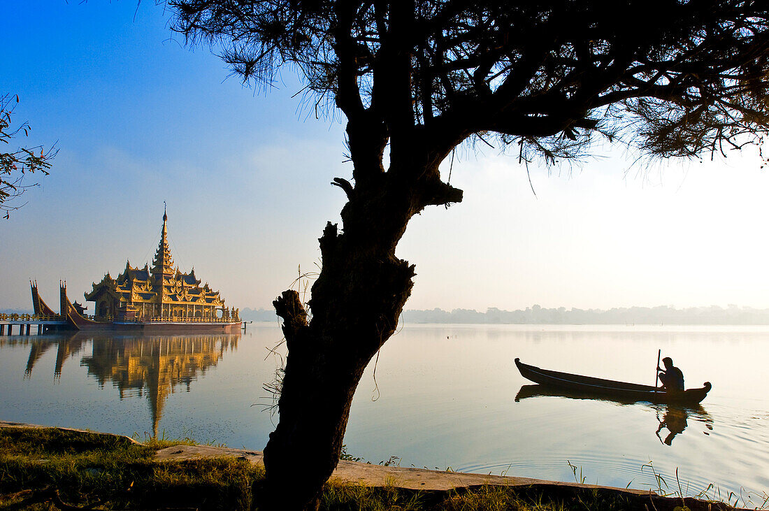 Myanmar (Burma), Mandalay Division, Mandalay, lake Kan daw Gwi, dugout canoe in front of restaurant pagoda Pyi Gimom
