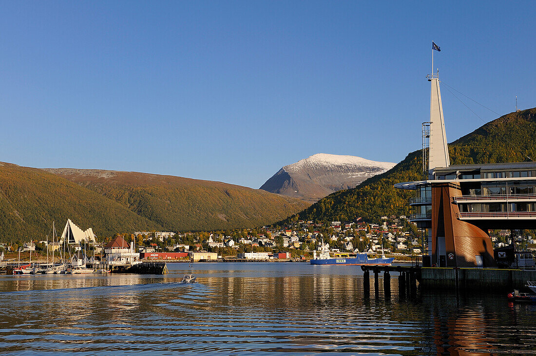 Norway, Troms County, Tromso, Rica Ishavshotell Hotel on the harbour, the Arctic Cathedral and Tromsdalstind Mount (1238 m) in the background