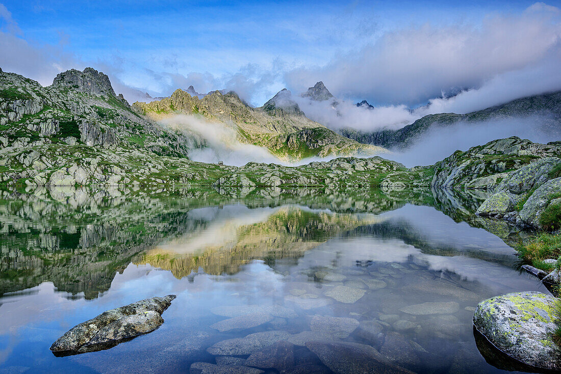 Mood of clouds above mountain lake, Lago Nero, Adamello-Presanella Group, Trentino, Italy