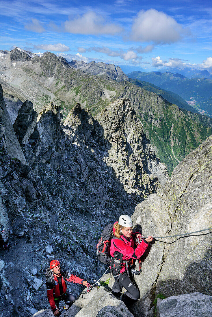 Man and woman climbing on fixed-rope route Sentiero dei Fiori, Sentiero dei Fiori, Adamello-Presanella Group, Trentino, Italy