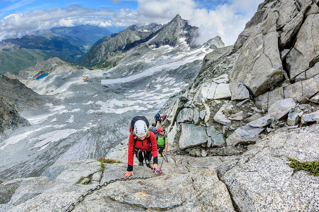 Man and woman descending from fixed-rope Sentiero dei Fiori towards glacier, Sentiero dei Fiori, Adamello-Presanella Group, Trentino, Italy