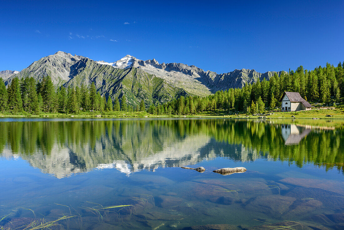 Mountain lake with chapel, Cima Presanella in background, lake lago San Giuliano, Val Genova, Adamello-Presanella Group, Trentino, Italy