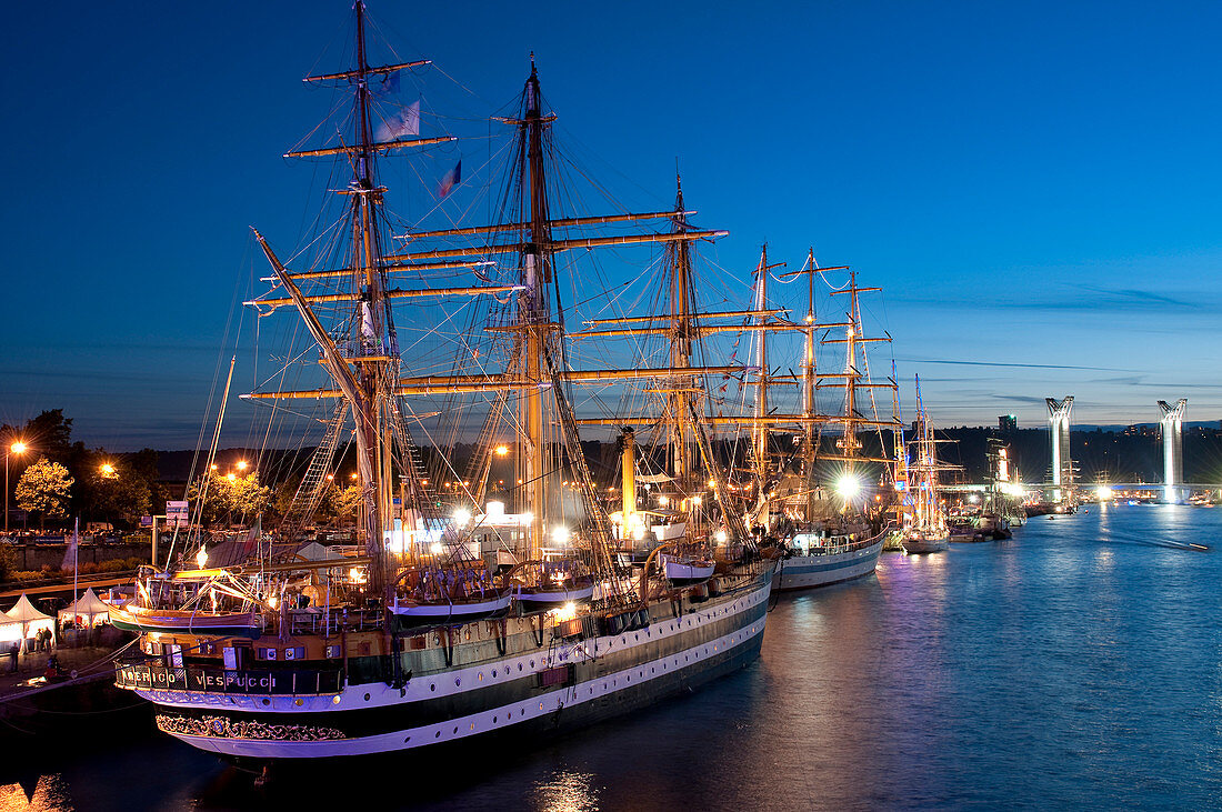 France, Seine-Maritime, Rouen, the Armada 2008 (concentration of sailboats) with the Amerigo Vespucci ship and the Gustave flaubert bridge illuminated in the background