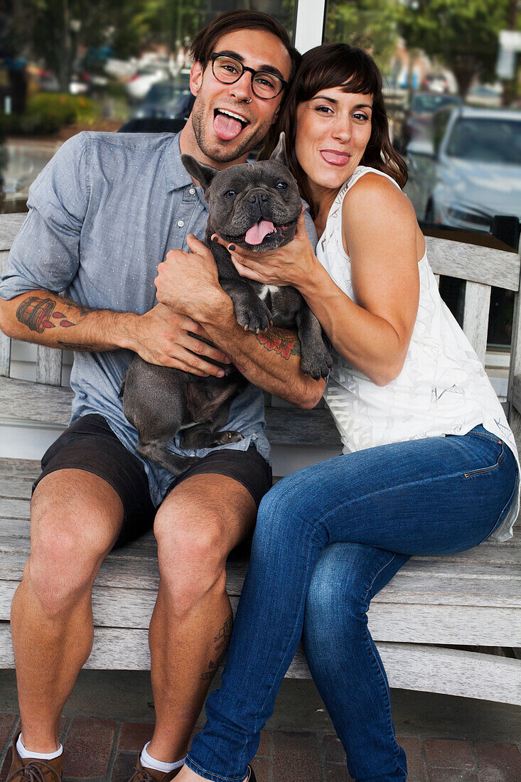 Caucasian couple imitating dog with tongue out