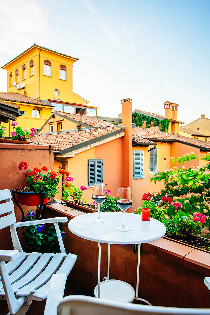 Wine glasses on balcony, Bologna, Emilia-Romagna, Italy