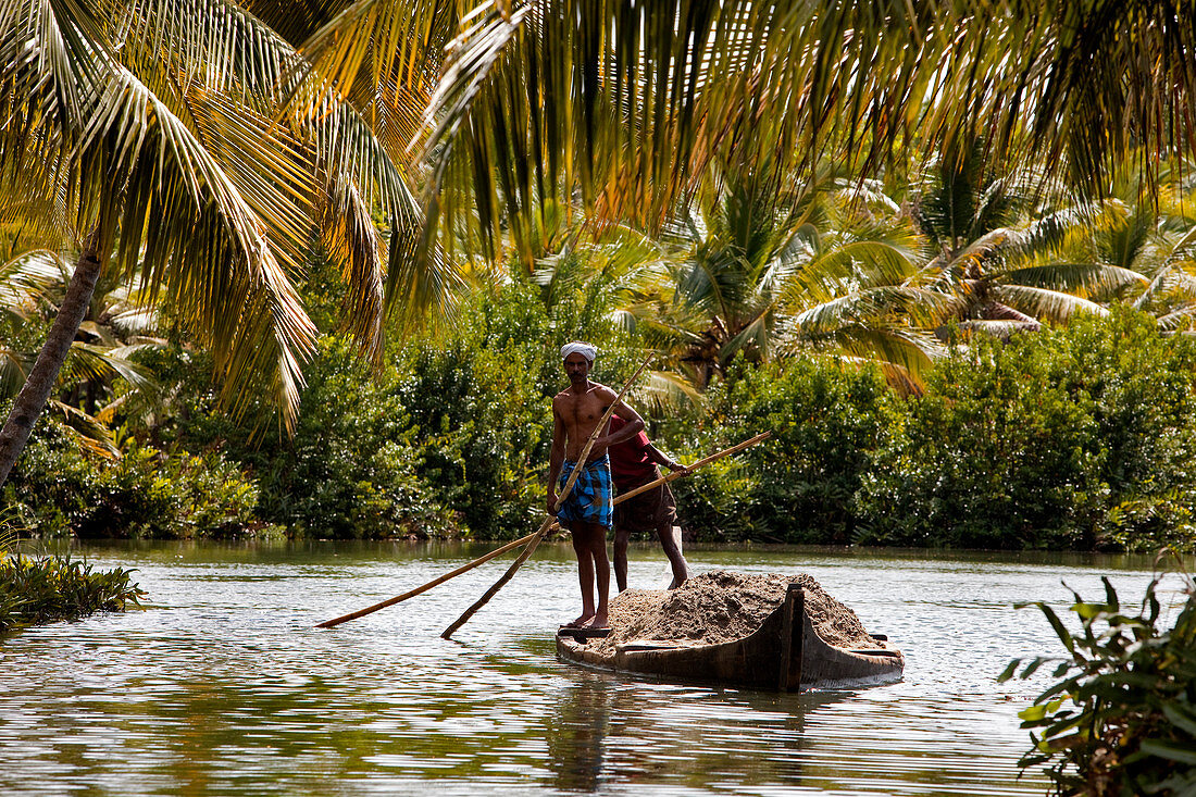 India, Kerala State, near Kollam, Munroe island, dugout canoe transporting sand
