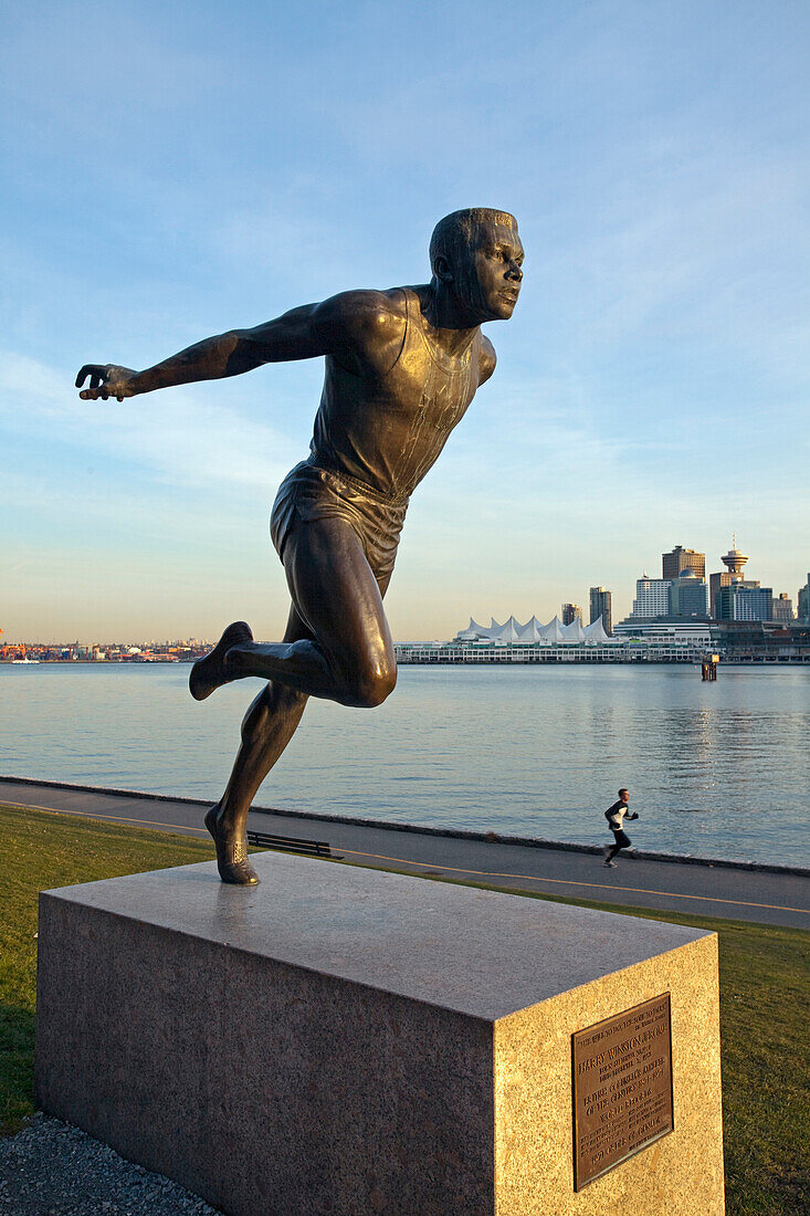 Canada, British Columbia, Vancouver, Stanley Park, the olympic runner Harry Jerome statue and in the background the downtown towers in sunset