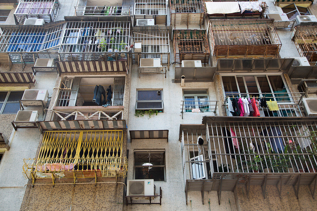 Laundry hangs from balconies on apartment building, Macau, Macau, China