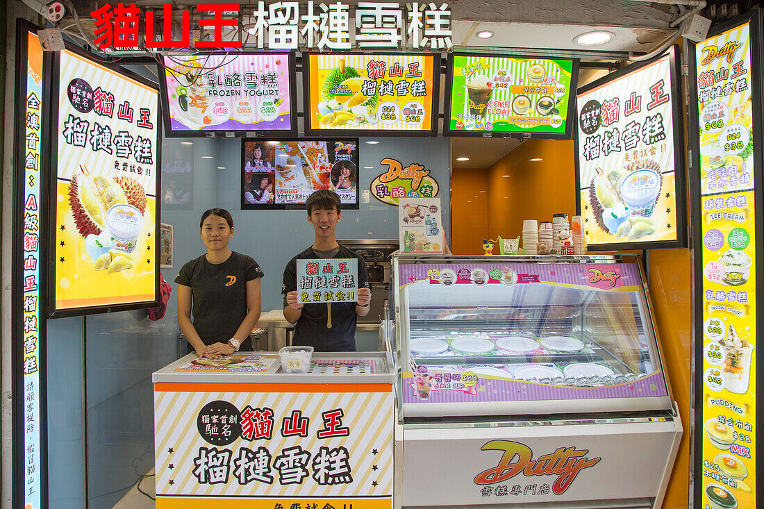 Two salesmen in colorful ice cream and snack shop, Taipa, Macau, China