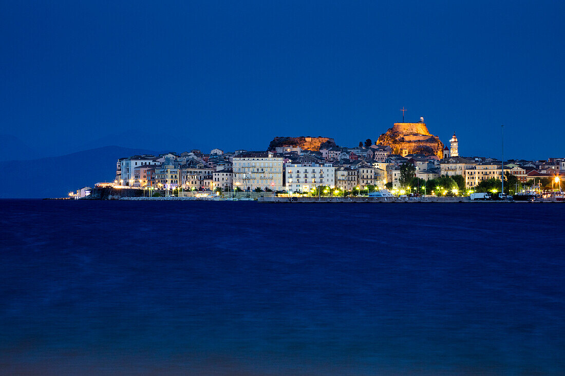 View from port to Corfu Old Town at dusk, Kerkyra (Corfu Town), Corfu, Ionian Islands, Greece