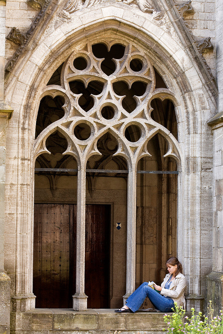 Netherlands, Southern Holland Province, Utrecht, cloister of the Dom cathedral, a young girl reading