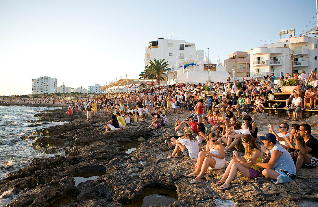 Spain, Balearic Islands, Ibiza island, Sant Antoni, every day at sunset, young people meet in front of the Cafe del Mar