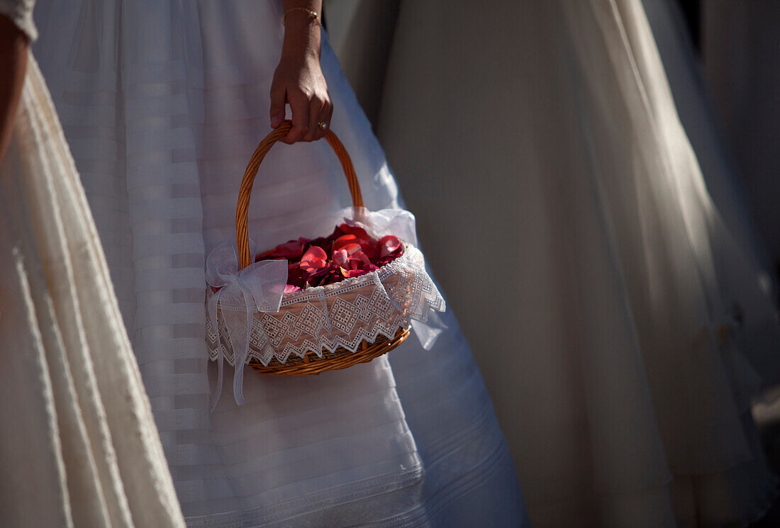 A girl holds a basket with rose petals during the Corpus Christi Catholic celebration in Prado del Rey, Cadiz, Andalusia, Spain, June 2,  2013.