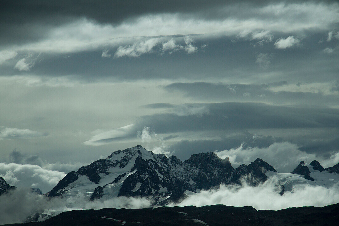 Clouds gather around the summit of mountain peaks near the Aysen Glacier region of Patagonia, Chile.