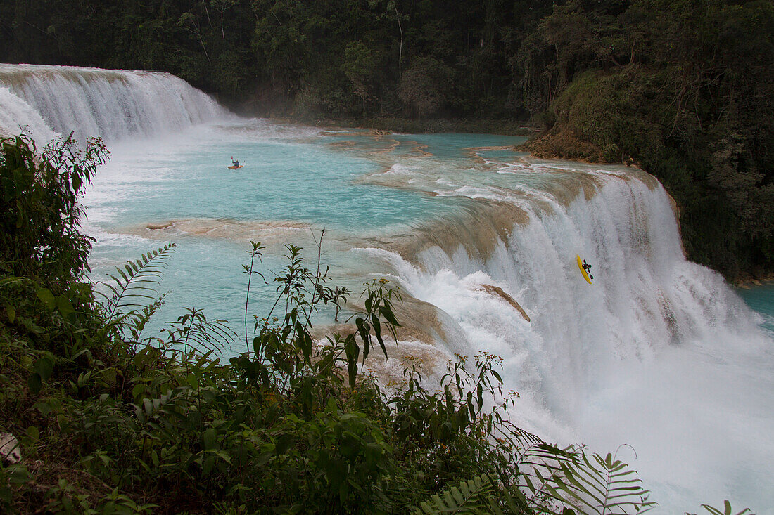 A kayaker has a less than perfect drop off a waterfall on the Rio Tulija, also known as Agua Azul in Chiapas, Mexico.