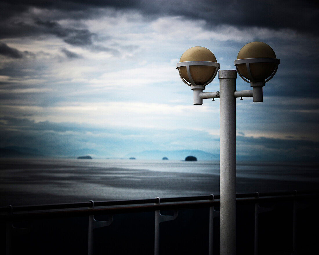 Stormy sky and the rainy Alaskan coastline from the deck of a cruise ship.
