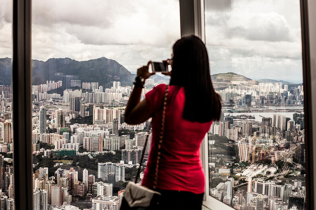Tourist taking picture of Hong Kong's Kowloon district