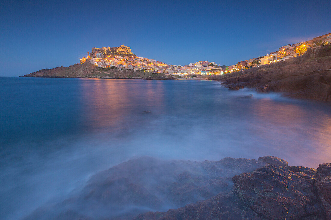 Waves frame the village perched on promontory at dusk, Castelsardo, Gulf of Asinara, Province of Sassari, Sardinia, Italy, Mediterranean, Europe