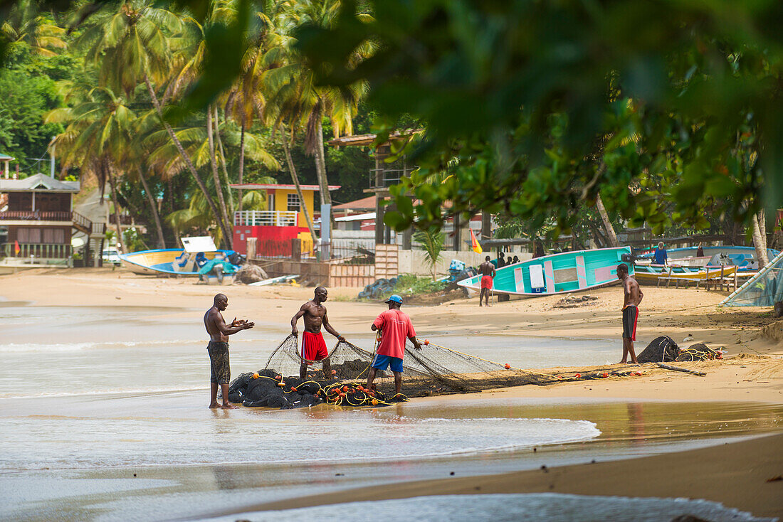 Fisherman organise their nets in Castara bay in Tobago, Trinidad and Tobago, West Indies, Caribbean, Central America