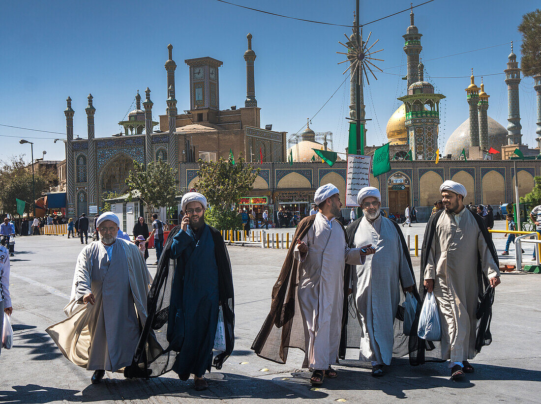 Chatting mullahs against the minarets of the Hazrat-e Masumeh (Holy Shrine), Qom, Iran, Middle East