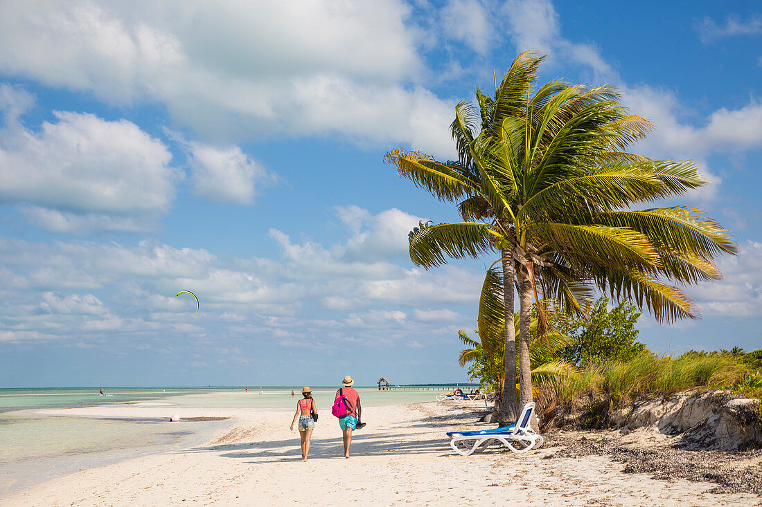 Couple walking along Playa El Paso, Cayo Guillermo, Jardines del Rey, Ciego de Avila Province, Cuba, West Indies, Caribbean, Central America