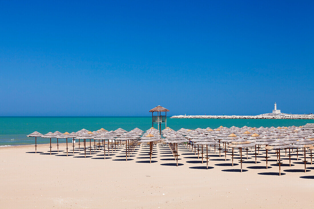 View over Spiaggia di San Lorenzo beach to the lighthouse on Isola di Sant'Eufemia Island, Vieste, Gargano, Foggia Province, Puglia, Italy, Europe