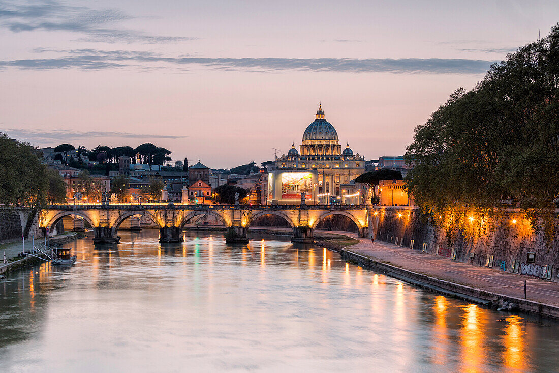 Dusk lights on Tiber River with bridge Umberto I and Basilica di San Pietro in the background, Rome, Lazio, Italy, Europe