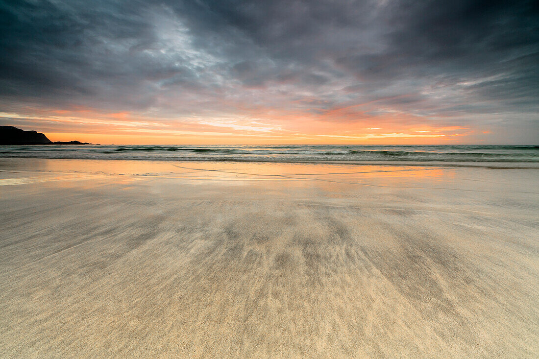 The midnight sun reflected on the sandy beach of Skagsanden, Ramberg, Nordland county, Lofoten Islands, Arctic, Northern Norway, Scandinavia, Europe